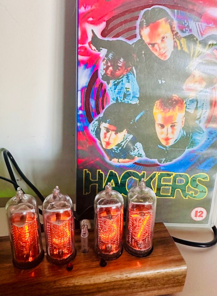 A Hackers VHS tape case made into a RGB lamp and a Nixie tube clock showing “13:37”