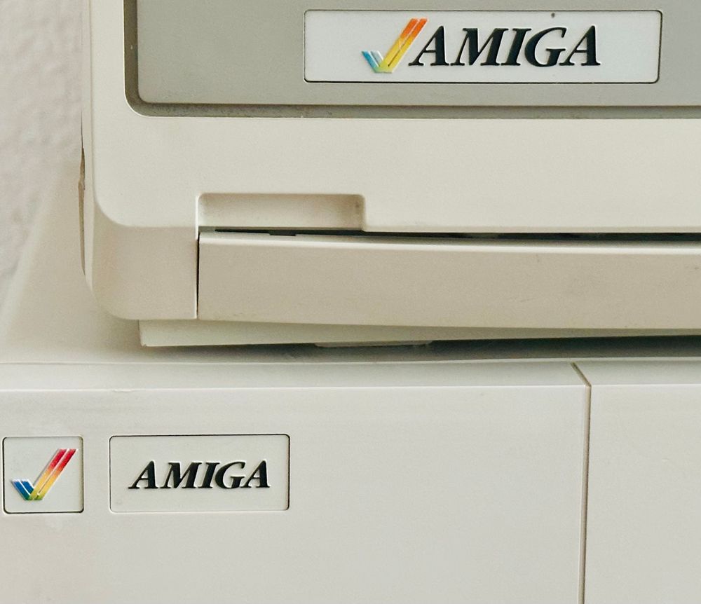Detail of rainbow checkmark badges on the OG Amiga and the OG Amiga monitor 
