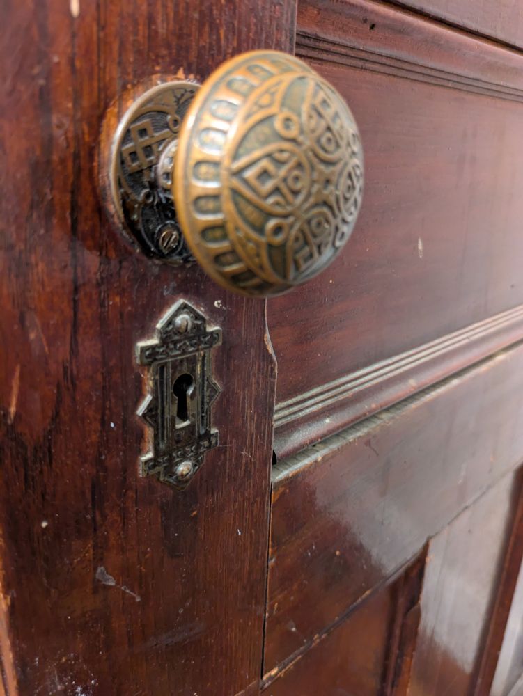 An ornate brass door knob.