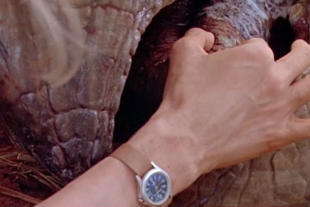 A closeup of the Timex Expedition on Ellie's wrist while she tends to the triceratops.