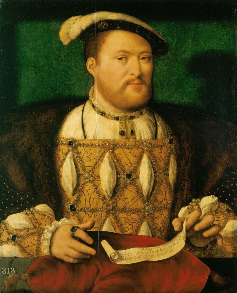 Henry VII wearing a cloth of gold doublet and a fur cape, as well as a jaunty hat, holding a piece of paper with writing on it. He is looking askance and is encrusted in jewels and pearls.