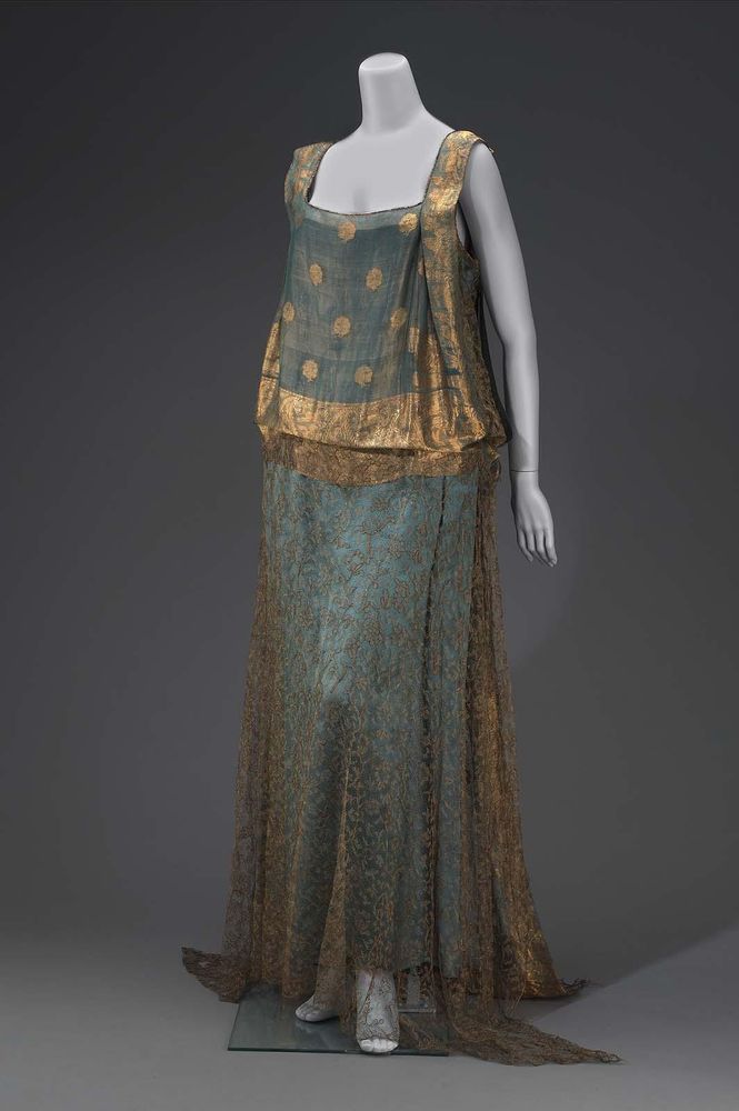 Made in part from an Indian sari of blue and gold; straight cut; blue satin slip; front of bodice and back, including short train, of sari; skirt of dress and underarm panels of gold lace; worn by Mrs. John D. Rockefeller, Jr.