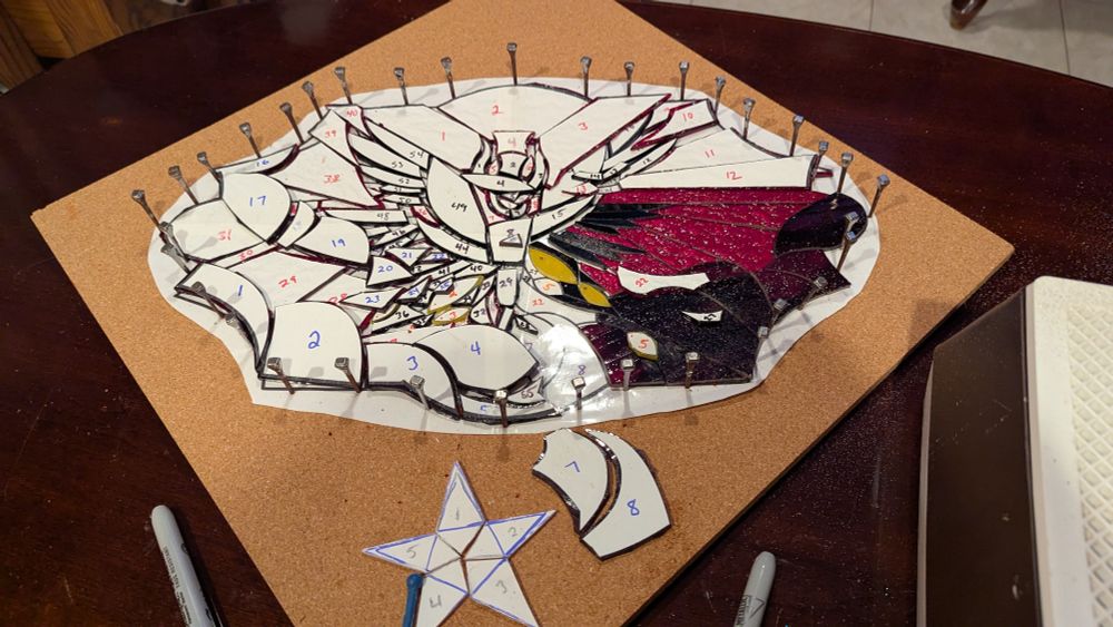 Stained glass pattern based on Lucifer from Hazbin Hotel Season 2 about 1/4 of the way done with grinding. 