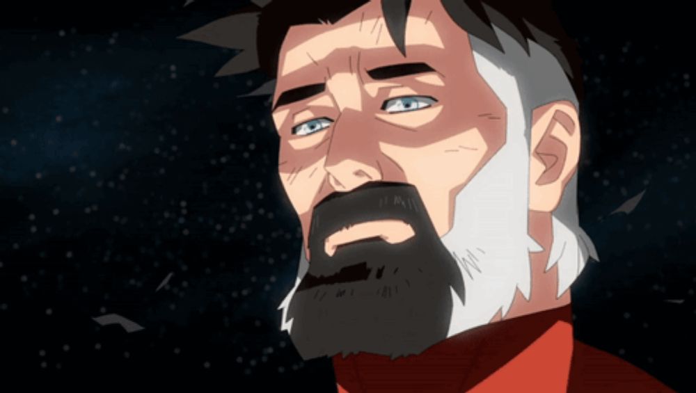 a man with a beard and a red shirt looks up into the sky