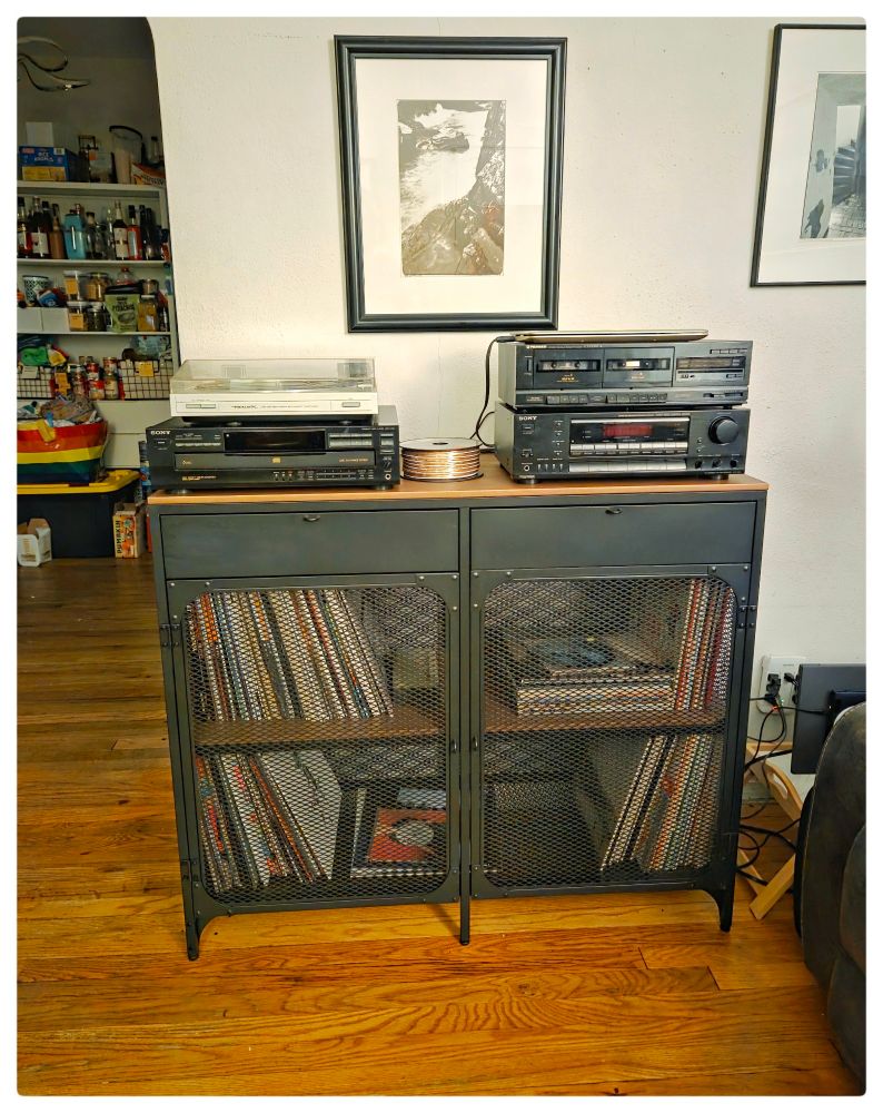 New IKEA sideboard-turned mega stereo cabinet. One drawer contains our cassette tape collections, the other is full of flashlights. Inside shelves full of vinyl records.