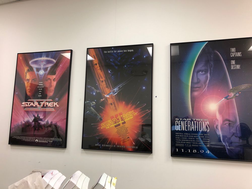 3 framed original movie posters on a white wall. The movies are Star Trek V:  The Final Frontier, Star Trek VI: The Undiscovered Country, and Star Trek Generations