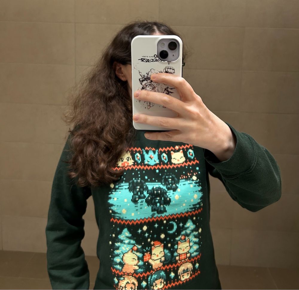 I have a Yetee Final Fantasy VI holiday sweatshirt featuring pixel art of a chocobo, Carbuncle, Moogles, Celes, Terra, Locke, and the Magitek mounts from the opening cutscene. I also have a Chrono Trigger phone case, which would normally not be visible but I took this photo in a mirror. My phone tried to autocorrect “moogles” to an all-caps version of the word. I must yell about Moogles a lot? Kupo.
