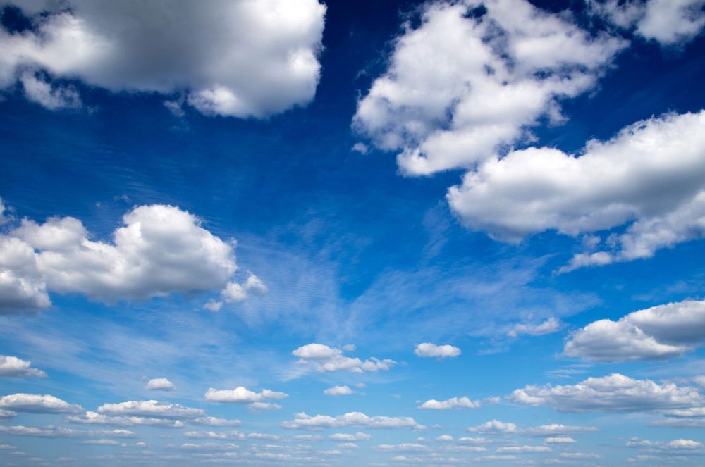 A blue sky with some fluffy clouds.