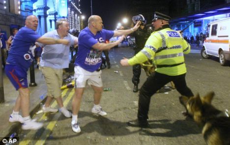 Rangers fans square up to Greater Manchester Police on the night of the 2008 Uefa Cup Final riots. Moments after this picture was taken, the dog in the bottom right corner bit one of the fans on the leg.