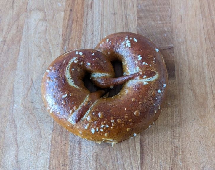 soft sourdough pretzel on a wooden surface