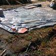 We lay a big sheet of plastic on the ground to make it easier to remove the stone we were using to make the concrete.
