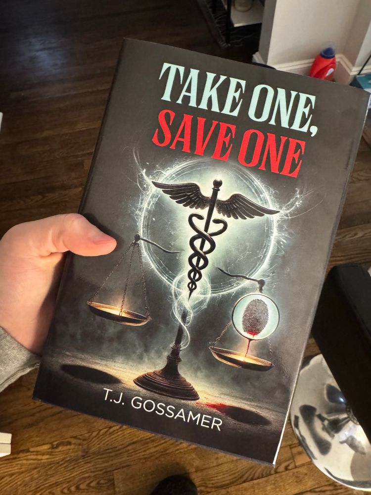 Hardcover book titled Take One, Save One by TJ Gossamer. There is a medical caduceus and slightly offset scales of justice.  