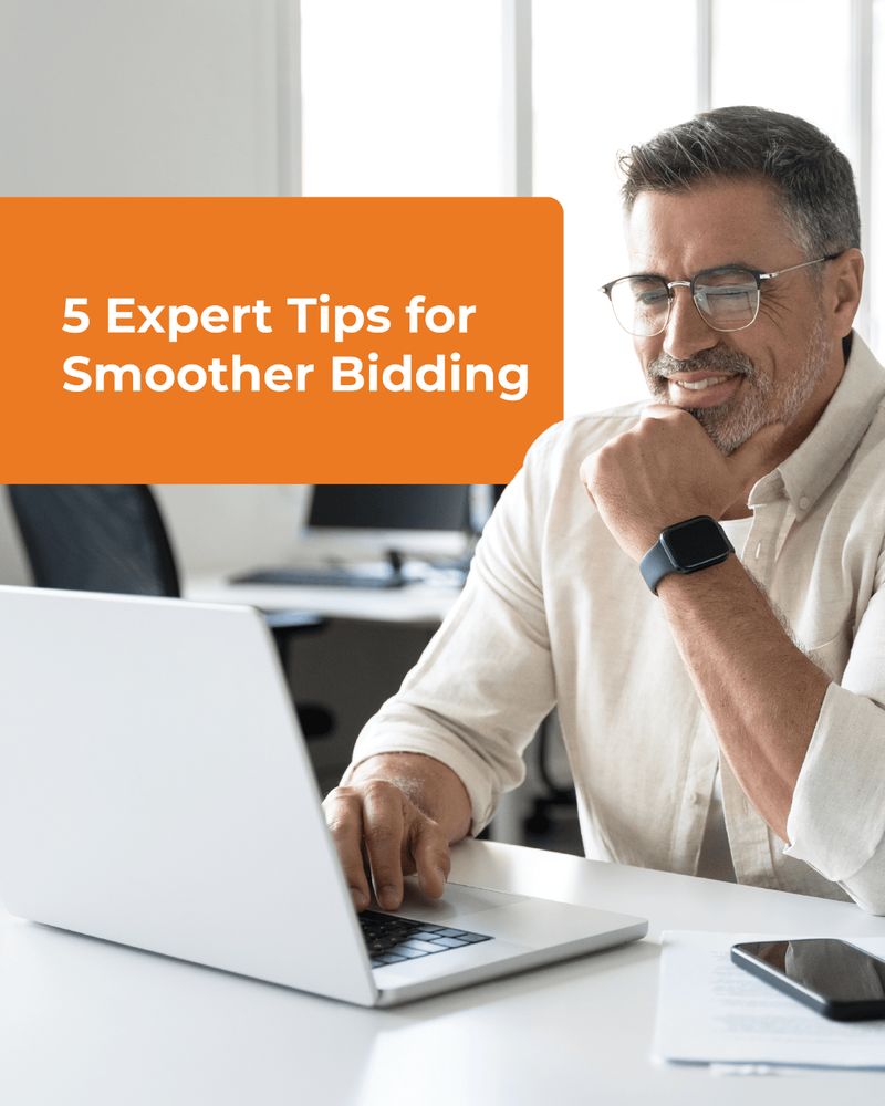 Man with eyeglasses and smartwatch sits smiling at a white laptop in a bright office. A smartphone and papers lie nearby. Orange text on the left reads, "5 Expert Tips for Smoother Bidding."