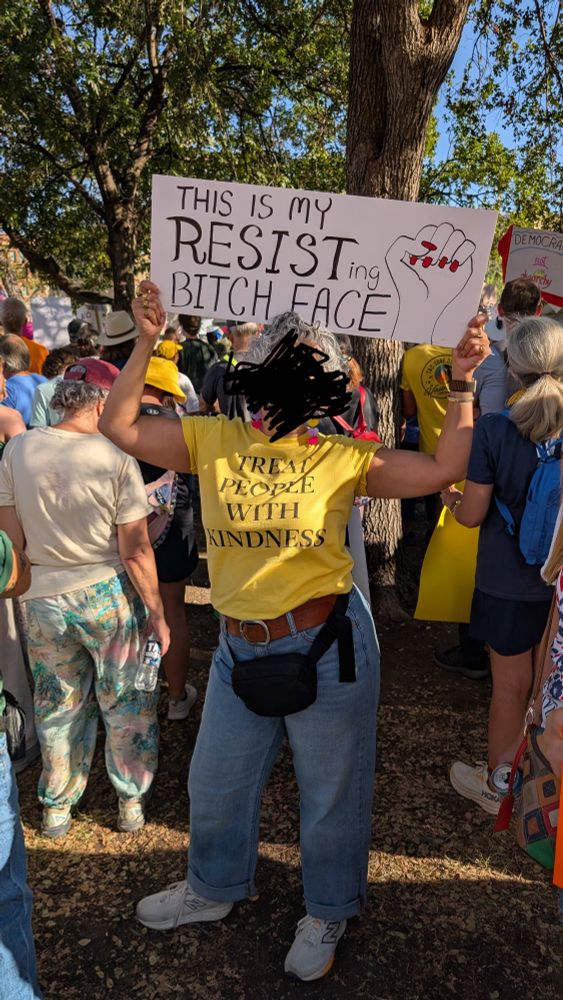 Woman with a This is my resisting bitch face sign. 
