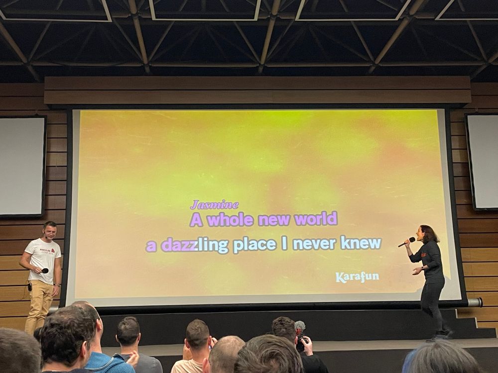 Two people singing on a stage at Balkan Ruby