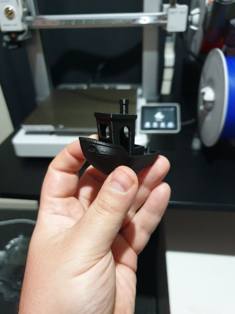 A small black benchy boat.