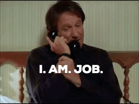 a man talking on a phone with the words " i am job " written below him