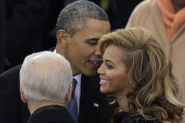 an older man talking to a younger woman making her smile