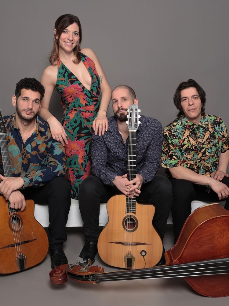Quartet of musicians - two are holding classical guitars and one has a double-bass