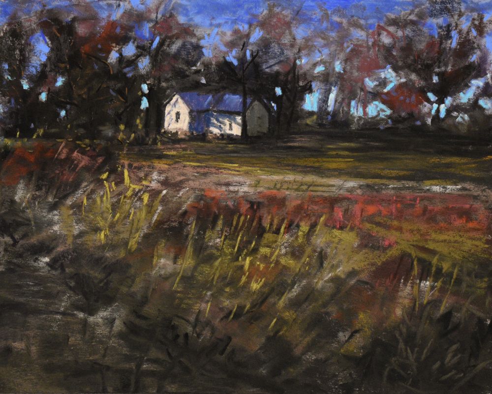 A photo of an 8x10” soft pastel painting. An old abandoned farmhouse sits in the background surrounded by trees. The foreground shows a ditch running up to a field that leads to the house. Blue sky peeks through the trees. 