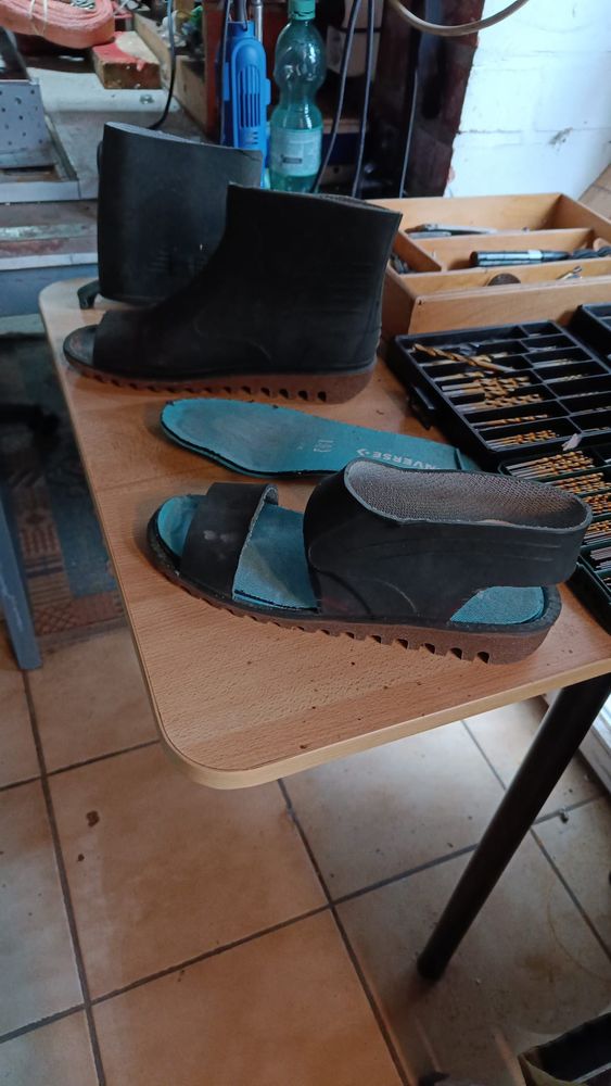 A pair of sandals cut out of an old pair of rubber boots.
