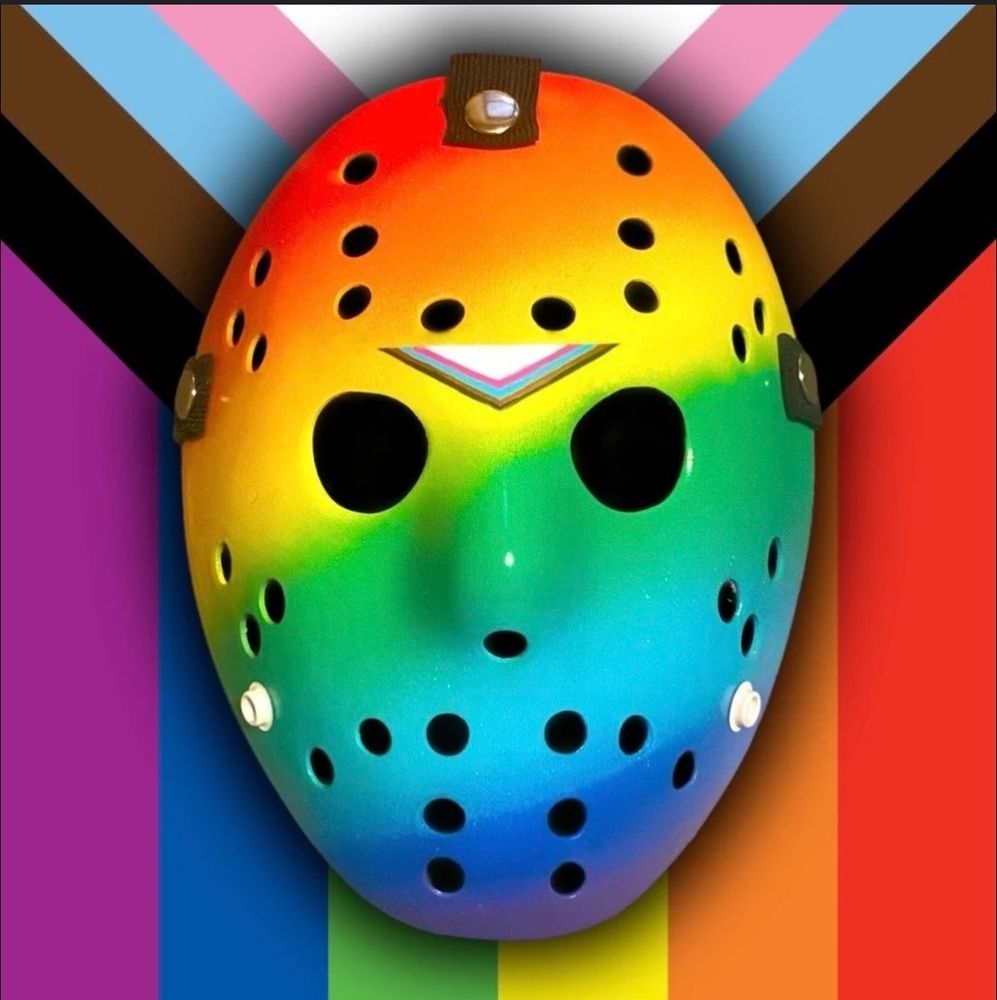 Rainbow-painted hockey mask in front of the Progress Pride Flag
