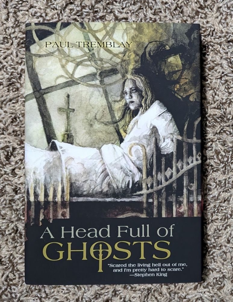 Hardcover of A HEAD FULL OF GHOSTS by Paul Tremblay w cover illustration by Daniele Serra