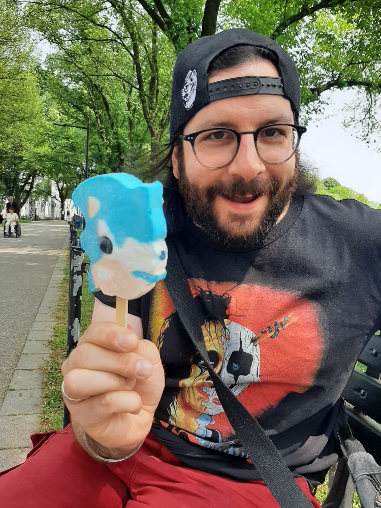 a hobbit-y looking dude holds up a nightmarish Sonic the Hedgehog ice cream 