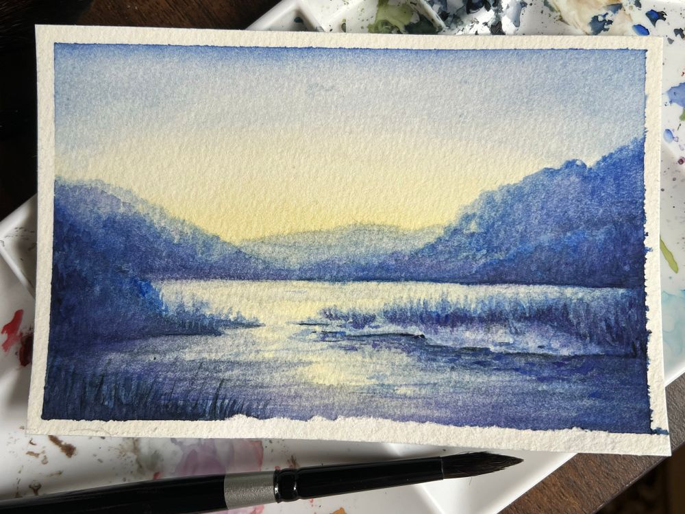 A beginner's watercolor painting study of a stream joining a river in the West Virginia mountains at daybreak. 