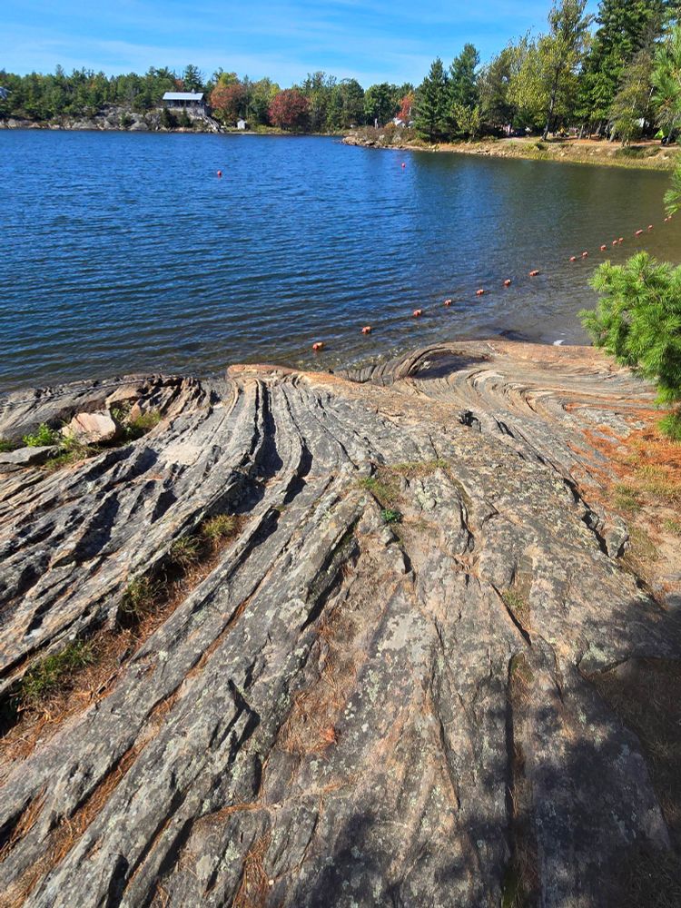 Beachfront rock formations at Sturgeon Bay Provincial Parl, with swirling ridges.