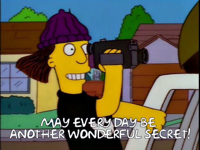JImbo Jones from the Simpsons in the "videotaping this crime spree is the best idea we ever had" scene, but it reads "may every day be another wonderful secret!"