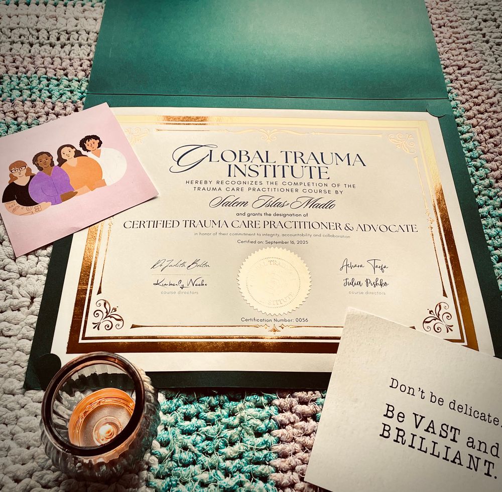 My certificate for Trauma Care Practitioner with two cards and a candle