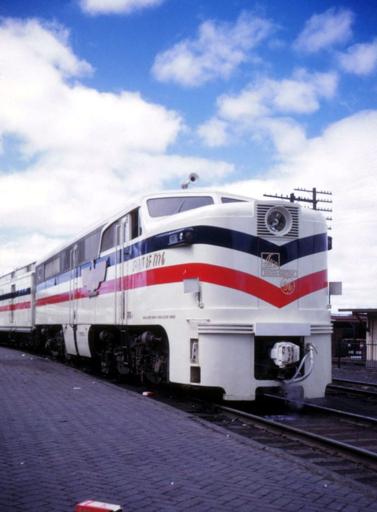 The 1947-49 Freedom Train locomotive, an ALCo PA lettered "Spirit of 1776". The locomotive is white (even the front coupler is painted white) with a red white and blue stripe running the length of the locomotive. There is also a large brass colored metal eagle on the side of the locomotive. 