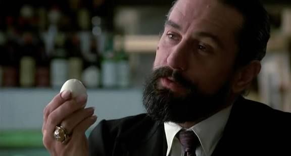 Robert de Niro as Louis Cyphre in "Angel Heart", contemplating a boiled egg.