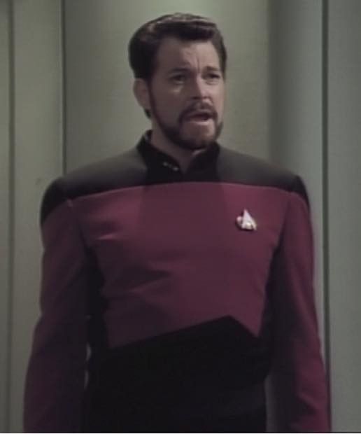 still of william riker standing in a turbolift with a kind of weird expression i cant really explain it sorry like his shoulders are back and his head is forward in a way i can only describe as defiant toddler 