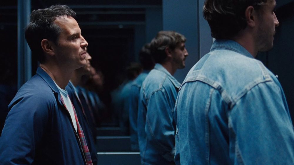 All of Us Strangers. Andrew Scott as Adam and Paul Mescal as Harry. Medium shot. Their reflections in the mirror behind them appear endless.