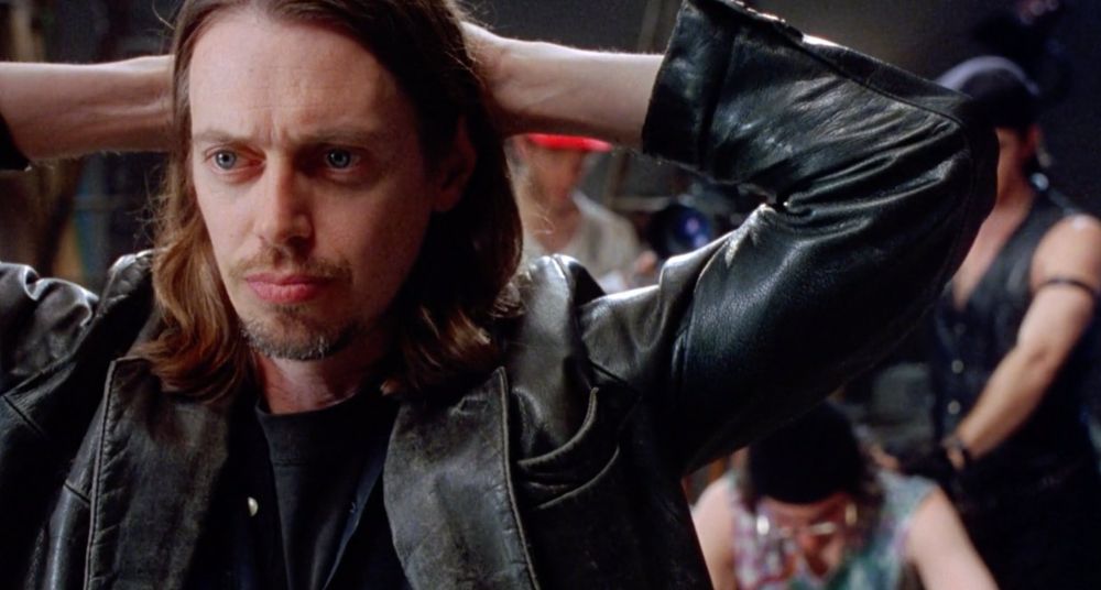 Living in Oblivion. Steve Buscemi as filmmaker Nick Reve. He’s wearing a leather jacket. His hair is down to his shoulders.