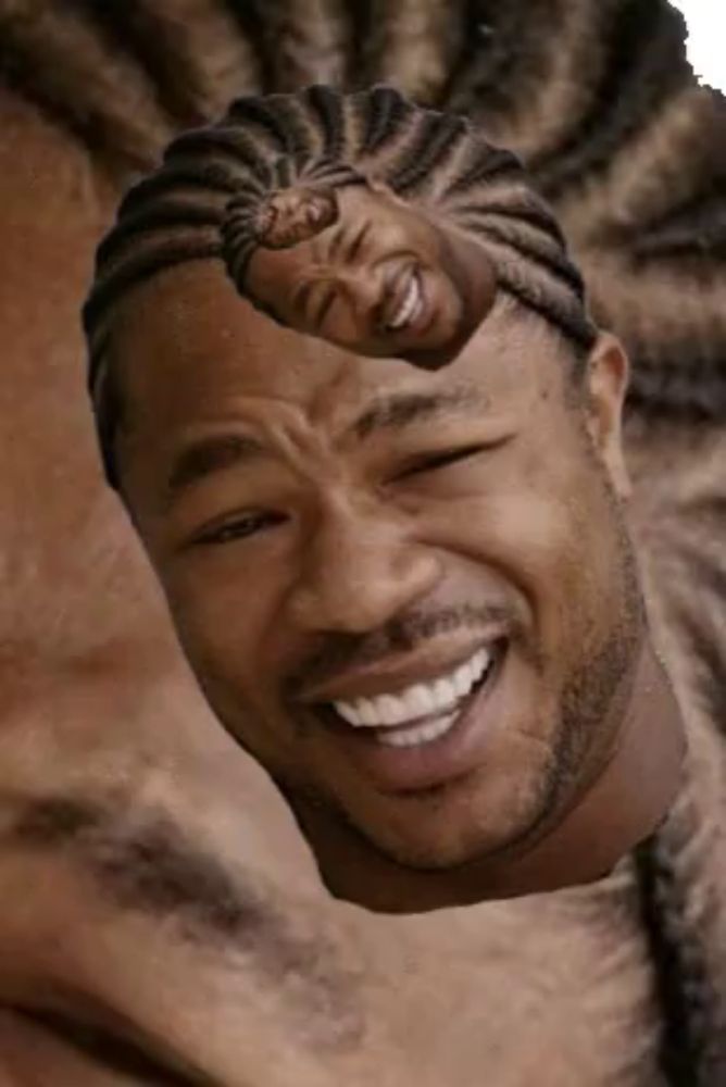 a close up of a man 's face with braids on it