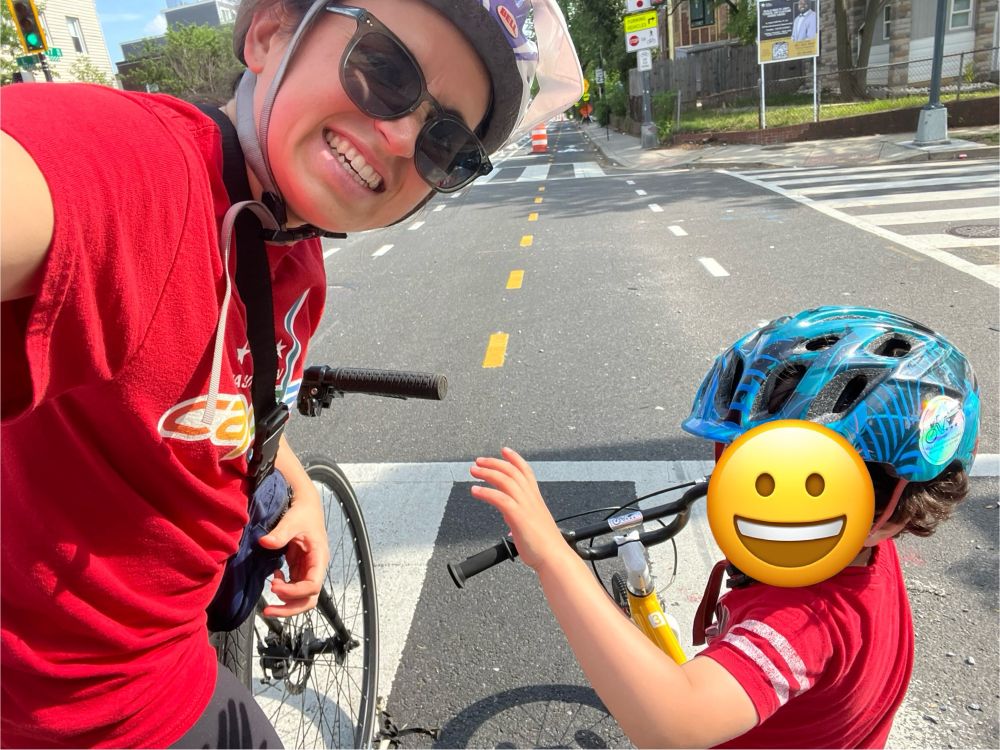 Mom and son riding in protected micro mobility lane on 17th st NE 