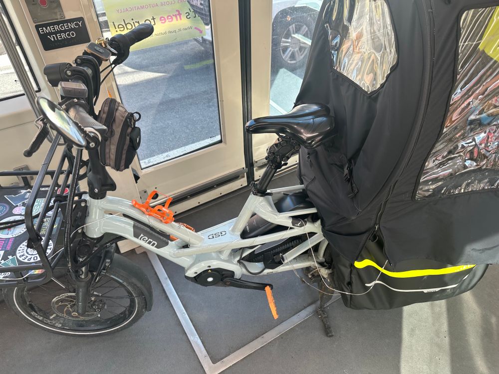 Tern GSD on a streetcar to get serviced at a bike shop. 