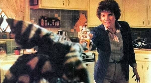 Still from Gremlins. Lynn Peltzer played by Frances Lee McCain spraying a gremlin in the face with bug spray shortly before microwaving him to death