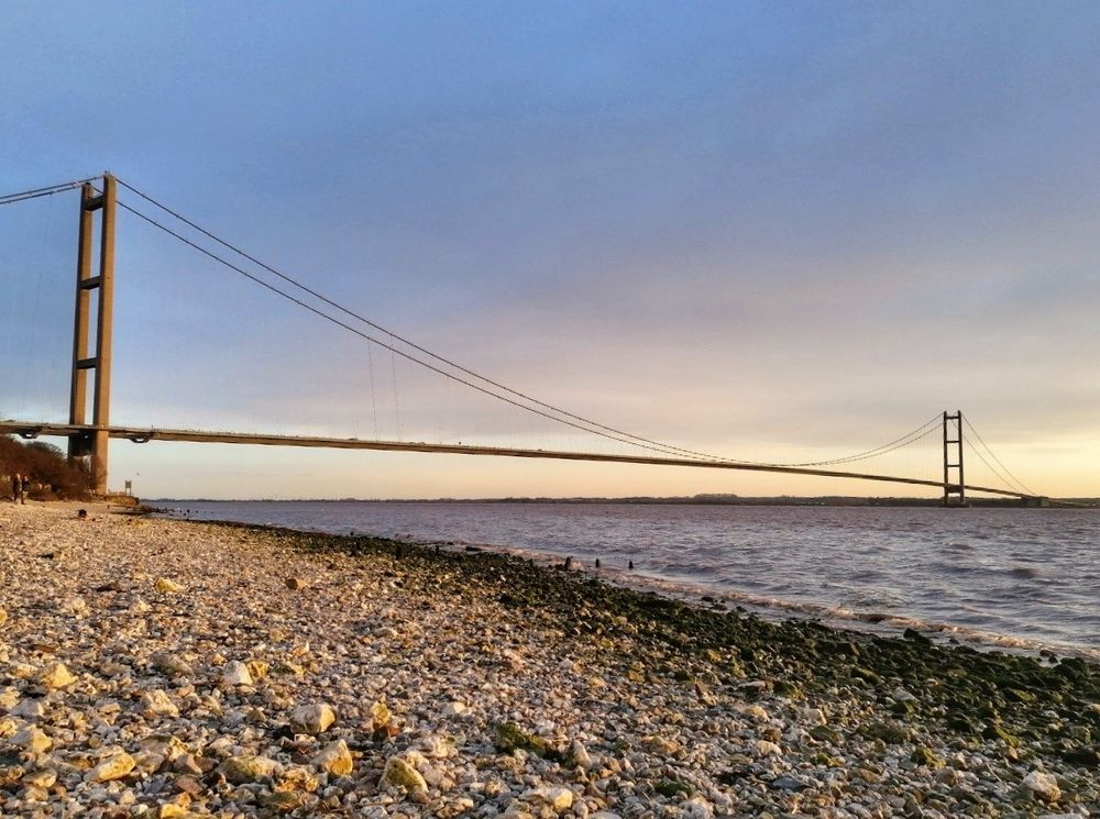 The classic view of the Humber Bridge. The view that tells you. You are nearly home. Taken from Hessle Foreshore. You also get the same view from the main railway line into Hull. Also the A63. The main road into Hull. It is England's longest suspension bridge. Taken in the late afternoon from the pebblely Foreshore 