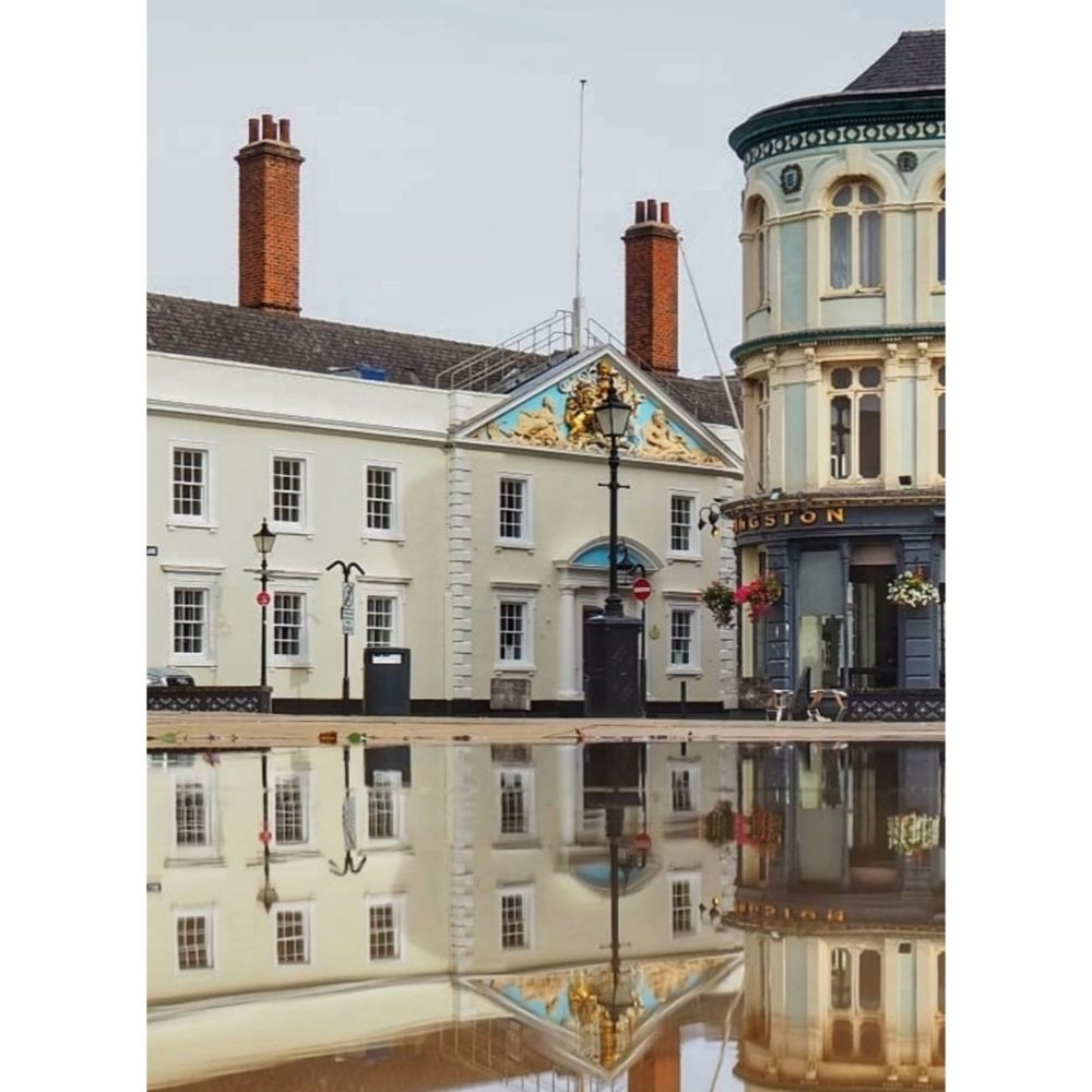 A near perfect reflection in the Trinity Square Mirror Pools of Trinity House and the Kingston Pub. 
