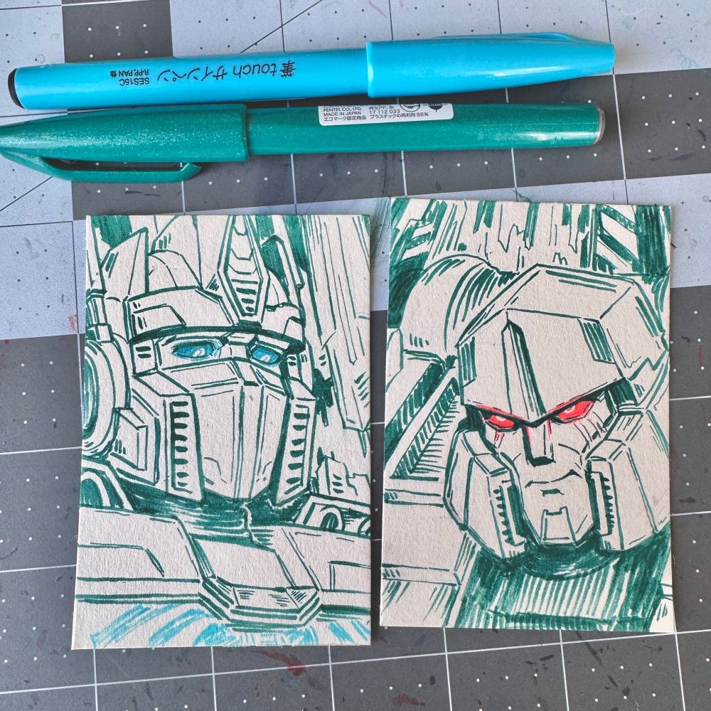 ink drawings of tf one optimus prime and megatron on cards