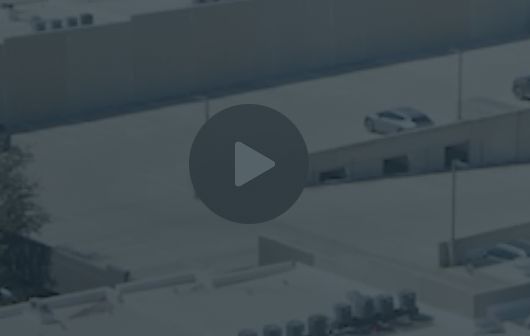 Large play button overlaid on a background image.