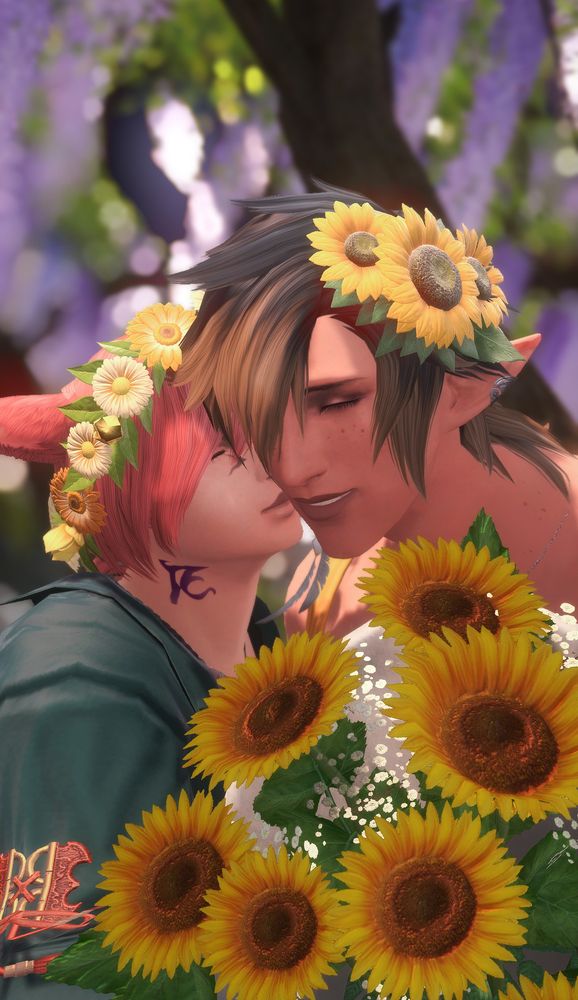 A screenshot of Aedric and G'raha together. Aedric is leaning over so G'raha can kiss him on the cheek. They are both wearing flowers in their hair while also holding a bouquet of sunflowers. 