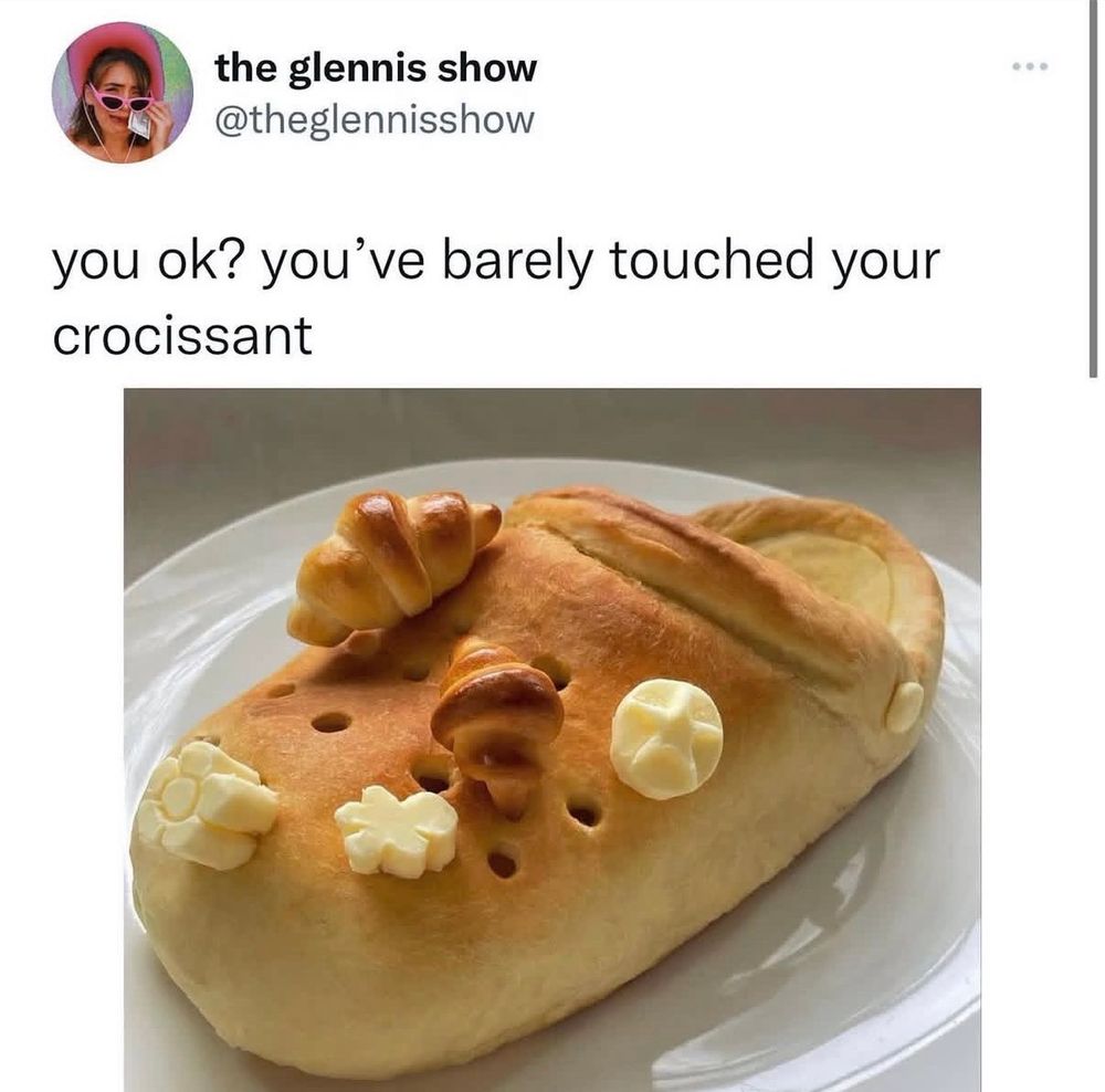 Screenshot of a post by the glennis show saying “you ok? You’ve barely touched your crocissant”. Below there is a picture of a croc shaped bread with croissant and butter shaped jibbitz’. 