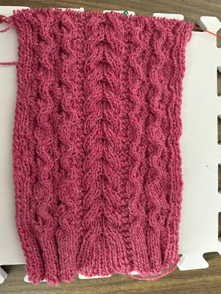 Hand knit scarf with cables in rose colored wool.