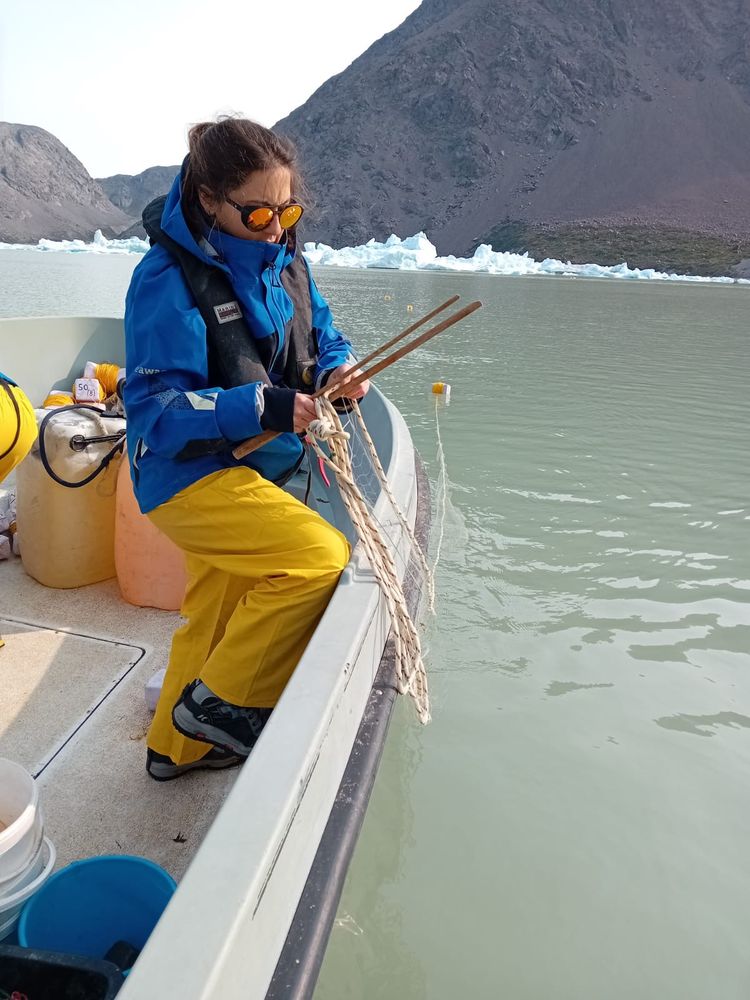 Me on a boat setting fishing nets in an icy fjord