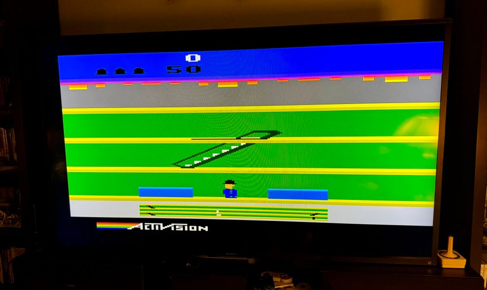 A screenshot of the 1983 game Keystone Kapers by Activision. It’s a game where you play as a police officer running after a crook. You must avoid many different obstacles while trying to catch the criminal.